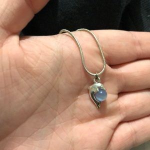 Dolphin bracelet holding a pearl from Disneyland